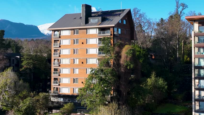 Volcano Behind Building In Pucon Los Lagos Chile. Volcano Showcasing The Raw Power And Beauty Of Nature. Town Sky Backgrounds Urban. Town Outdoor Downtown Panning Wide. Pucon Los Lagos.