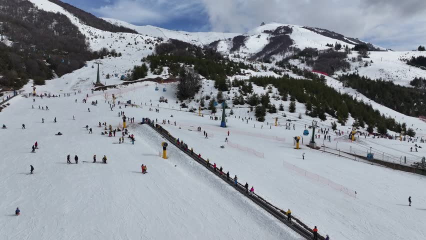 Cerro Catedral In Bariloche Rio Negro Argentina. Skier Skiing Downhill On Empty Ski Slopes In The Mountains. Nature Tourism Icon Snow Covered Forest Trees. Nature Discover Aerial.