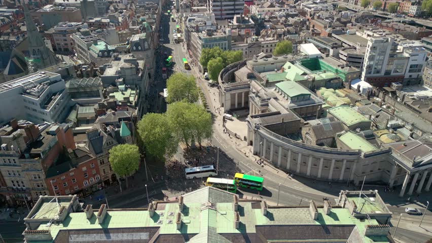 Wide, reversing aerial video of the campus and surrounding areas of Trinity College in Dublin, Ireland on a bright and sunny day. Filmed in 4K, 60FPS and with Rec709 color.