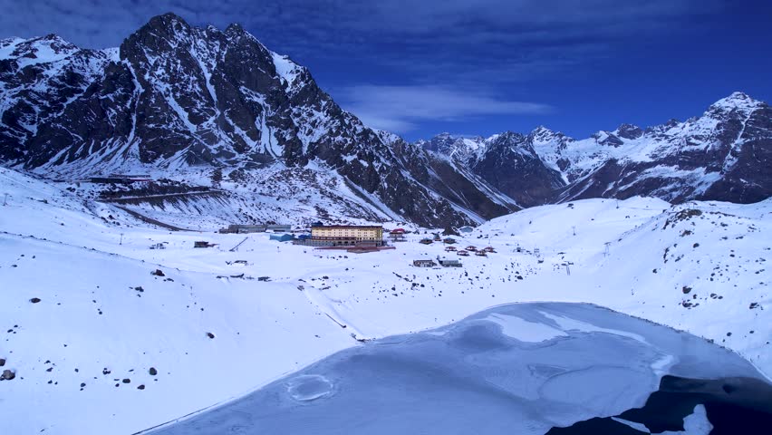 Portillo Ski Station In Andes Mountains Valparaiso Chile. Skier Skiing Downhill On Empty Ski Slopes In The Mountains. Snowy Countryside Andes Mountains Map Blizzard.