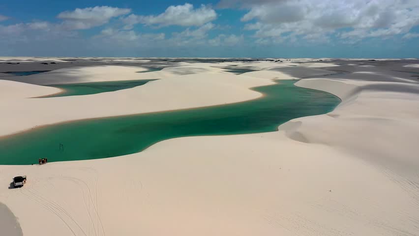 Sand Dunes In Lencois Maranhenses Maranhao Brazil. Turquoise Lagoons And Sand Dunes Creating Inspiring Landscape. Nature Dramatic Clouds Mountain Canyon. Mountain Waterfall Powerful Flow.