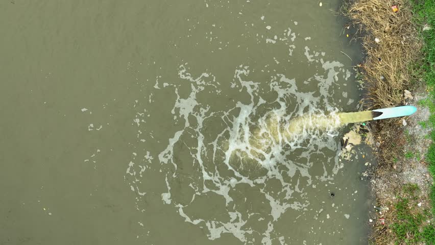 Aerial view of water discharge into a field canal, highlighting water usage in agriculture to sustain crops and support irrigation systems critical for food production.
