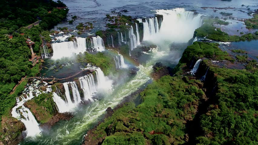 Iguazu Falls In Puerto Iguazu Misiones Argentina. Cliffside Surrounded By Lush Green Forest Viewed From Above. Landscape Sky Clouds Waterfall Tropical. Landscape Waterfall Panoramic Florest.