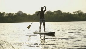 Man Sup Surfing .Stand up Paddling Surfboard. Inflatable Board For Rowing. Surfer Balance Watersport Activities. Travelling Water Tourism. Raft On SUP. Paddler Surfing Exploration Tranquil River - Powered by Shutterstock - Get 15% off with code: PIKWIZARD15