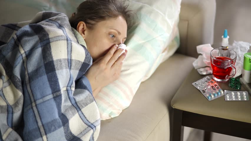 Sick Woman Fatigue High Temperature. Seasonal Cold Home Treatment. Unhealthy Sick Flu Virus Illness. Unwell Illness. Sick Woman Remedy Nasal Spray. Severe Cold  Suffering Flu ill Common Cold Symptoms