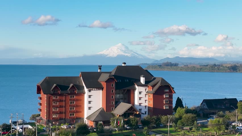 Osorno Volcano In Puerto Varas Los Lagos Chile. Snow-Capped Volcano Releasing Plumes Of Smoke Into Blue Sky. Snowing Day Lake Glacial Blizzard. Glacial. Puerto Varas Los Lagos.