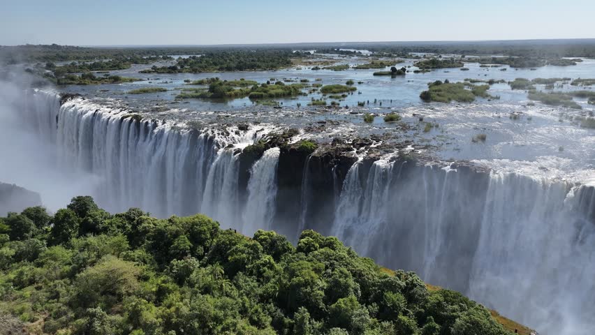 Wild Water Falls In Victoria Falls Matabeleland North Zimbabwe. Stunning Waterfalls Flowing In Natural Wonder Landscape. Landscape Sky Waterfall Tropical. Outside Waterfall Panorama.
