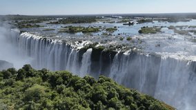 Wild Water Falls In Victoria Falls Matabeleland North Zimbabwe. Stunning Waterfalls Flowing In Natural Wonder Landscape. Landscape Sky Waterfall Tropical. Outside Waterfall Panorama. - Powered by Shutterstock - Get 15% off with code: PIKWIZARD15