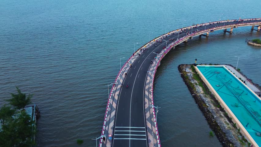 Aerial view of the beach and Surabaya bridge constructions. Suroboyo Kenjeran Bridge landmark in Surabaya. Surabaya city harbour bridge