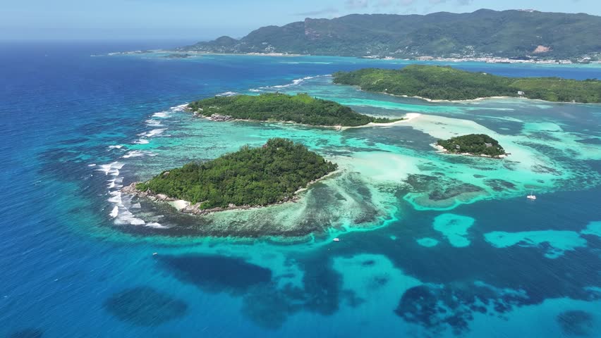 Seychelles Archipelago In Victoria Seychelles Islands Seychelles. Turquoise Ocean Waves Gently Crashing On Tropical Beach. Deserted Skyline Leisure Wanderlust. Leisure Water Edge Shore.