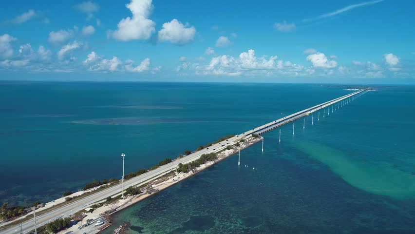 Giant Bridge In Key West Florida United States. Traffic Is Moving Across A Modern Cable-Stayed Bridge. Shore Sky Clouds Beach Sea. Shore Seaside Panorama. Key West Florida.