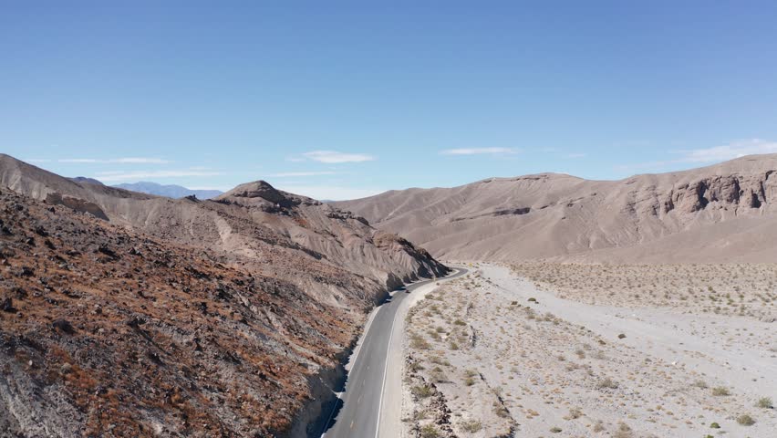 Aerial low rising shot of a road at the park entrance to Death Valley National Park in California. 4K