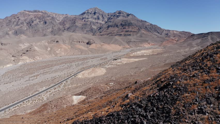 Low aerial shot flying over the rugged desert landscape of Death Valley, California. 4K