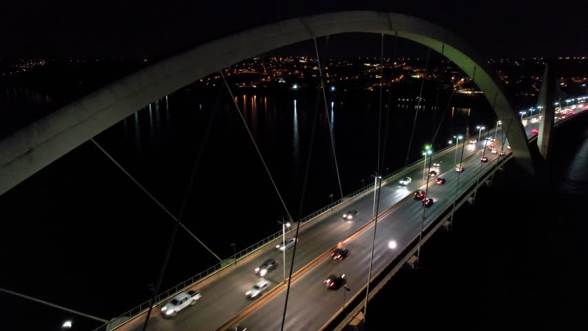 Juscelino Kubitschek Bridge In Brasilia Federal District Brazil. Aerial View Of Landmark Bridge Showcasing Its Intricate Design . Building Clouds Sky Downtown Cityscape. Night Outdoors Panning Wide.