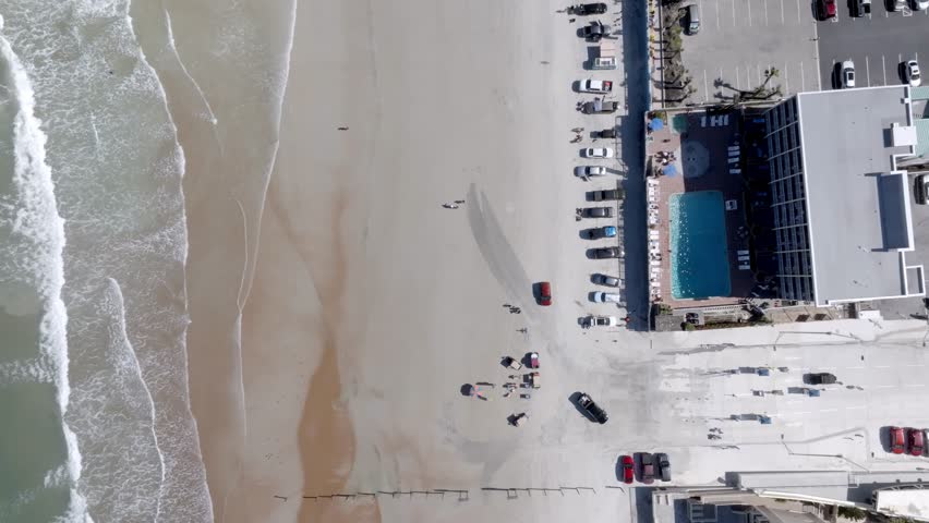 Daytona Beach, Florida with waves from Atlantic Ocean and drone video overhead, looking down and stable.