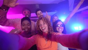 Diverse group of young friends capturing joyful selfie moment during energetic nightclub party, sharing infectious happiness and vibrant nightlife experience - Powered by Shutterstock - Get 15% off with code: PIKWIZARD15