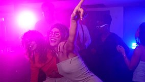 Women dancing and enjoying vibrant music with friends, sharing infectious energy at bustling nightclub party with pulsing beats and colorful atmosphere - Powered by Shutterstock - Get 15% off with code: PIKWIZARD15