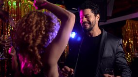 Vibrant couple dancing closely, sharing infectious joy with friends during energetic nightclub celebration, experiencing nightlife excitement and connection - Powered by Shutterstock - Get 15% off with code: PIKWIZARD15