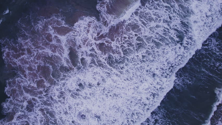 Top down aerial view from above of waves crashing and foaming on beach sand,Amazing sea nature background,Wide angle view beach sea from drone camera 4k High quality footage ProRes 422