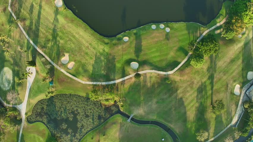 Aerial view of Golf Course with putting green grass and trees on golf field Fairway and putting green top view Amazing bird eye view over Golf courses in summer sunny day