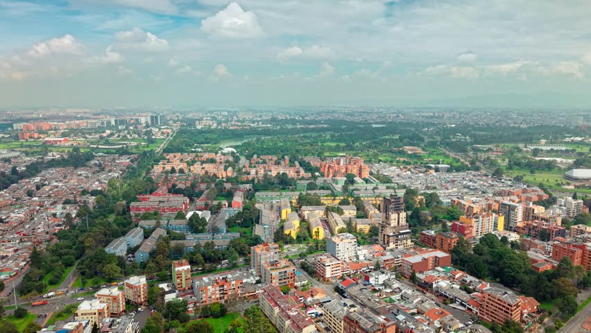 Panoramic aerial view of Bogota Colombia with orange brick residential buildings near Simon Bolivar Park on a sunny day.