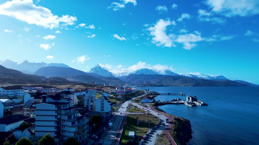 Scenic City In Ushuaia Tierra Del Fuego Argentina. Modern City Center With Skyscrapers Reflecting The Urban Life. Snowing Day Lake Glacial Landscape Blizzard. Snowing Day Forest Trees.