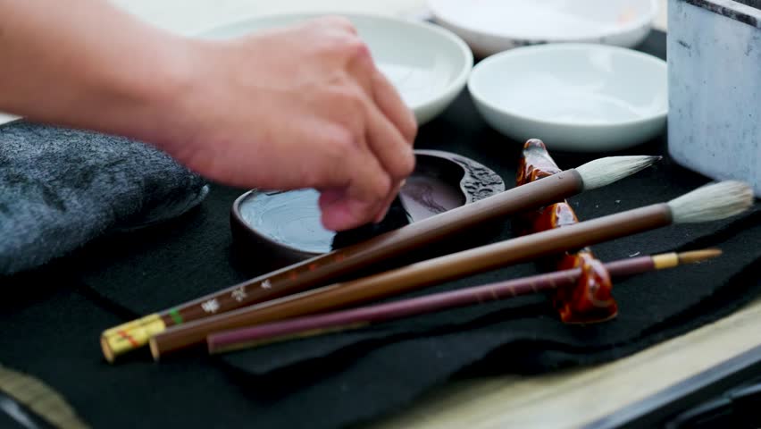 Footage of a Japanese Man Painting a Nihonga, a Traditional Japanese Painting, with Brushes and Black Ink