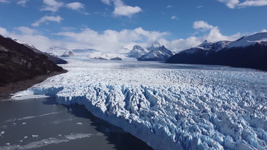 Perito Moreno Iceberg In El Calafate Santa Cruz Argentina. Stunning View Of Icebergs Breaking Off Into The Water . Outdoor Travel Destination Patagonia Glacier. Landmark Patagonia Aerial.