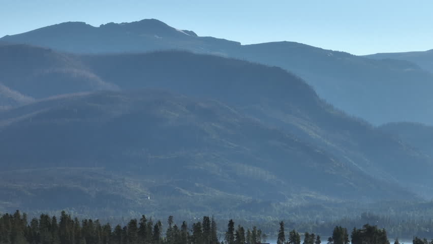 Telephoto drone shot of the Rocky Mountains in Grand Lake, Colorado at sunrise