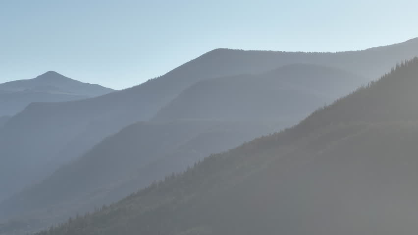 Telephoto drone shot of the Rocky Mountains in Grand Lake, Colorado at sunrise
