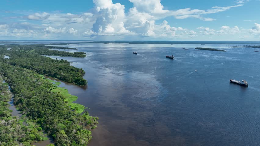Amazonian Forest In Manaus Amazonas Brazil. Amazon River Showing Lush Green Foliage And Riverboats. Travel Flyover Wilderness Jungle. Travel Panning Wide. Manaus Amazonas.