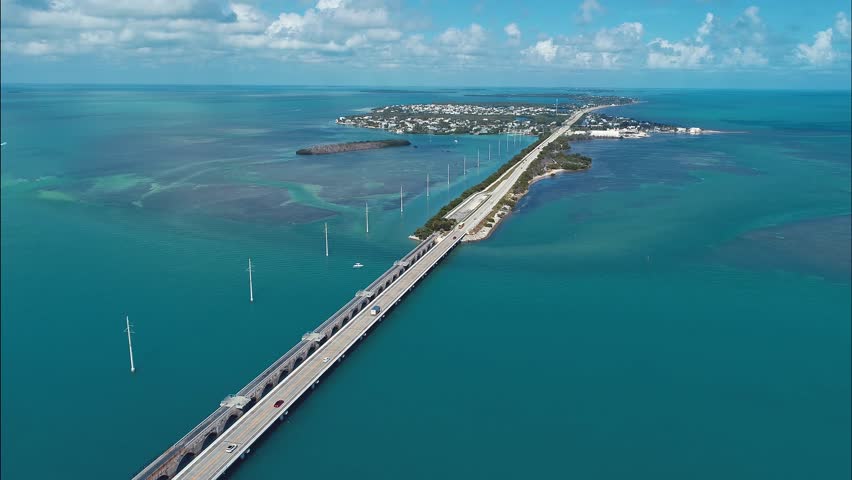 7 Mile Bridge In Key West Florida United States. Traffic Is Moving Across A Modern Cable-Stayed Bridge. Shore Horizon Beach Sea. Seaside Panning Wide. Key West Florida.