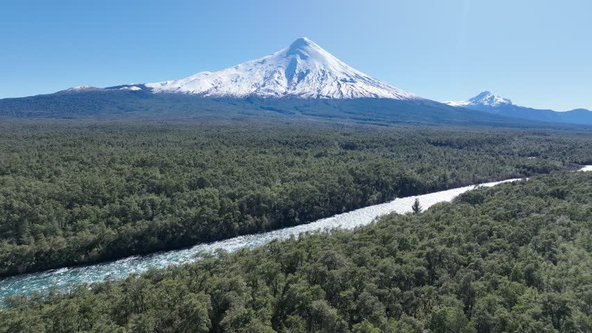 Osorno Vulcan In Petrohue Los Lagos Chile. Volcano Showcasing The Raw Power And Beauty Of Nature. Nature Travel Destination Snow Covered Forest Trees. Nature Sky Patagonia Aerial View.