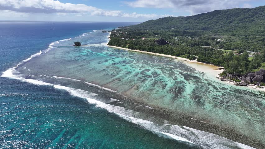 Anse Source D Argent Beach In La Digue Island Victoria Seychelles. Breathtaking Aerial View Of A Lush Tropical Coastline Scenery. Shore Sky Clouds Beach Sea. Shore Seaside Panorama.