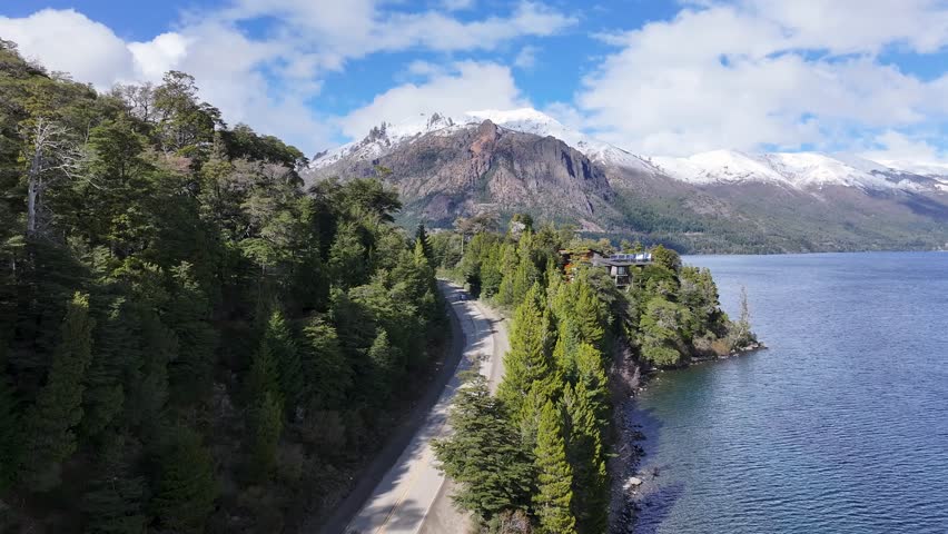 Patagonia Road In San Carlos De Bariloche Rio Negro Argentina. Breathtaking Aerial View Of Busy Traffic In A Freeway Road. Nature Tourism Icon Snow Covered Forest Trees. Nature Discover Aerial.