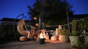 Backyard nighttime ambiance, potted plants, garden furniture, fire pit - Powered by Shutterstock - Get 15% off with code: PIKWIZARD15