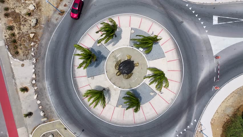 Sea Turtle Roundabout In Oranjestad Caribbean Netherlands Aruba. Urban Life Landscape Of Freeway Road Connecting City Streets. Shore Clouds Sky Beach Sea. Shore Beach Scenic Coastline.
