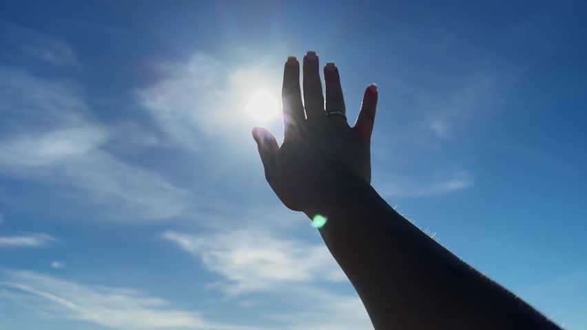 Silhouette of happy dreaming girl pulls her hand to sun. Happy girl silhouette at sunset. Harmony with nature. High quality 4k footage