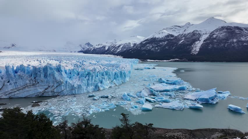 Perito Moreno Glacial In El Calafate Santa Cruz Argentina. Aerial View Of Massive Glacier Calves Into A Lagoon Of Icy Water. Outdoor Travel Patagonia Glacier. Snow Covered High Angle View.