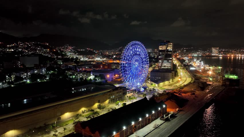 Night Ferris Wheel In Rio De Janeiro Brazil. Bird Eye View Of Stunning Ferris Wheel In A Amusement Park. Building Sky Illuminated Urban. Town Outside Downtown Panorama. Rio de Janeiro Brazil.