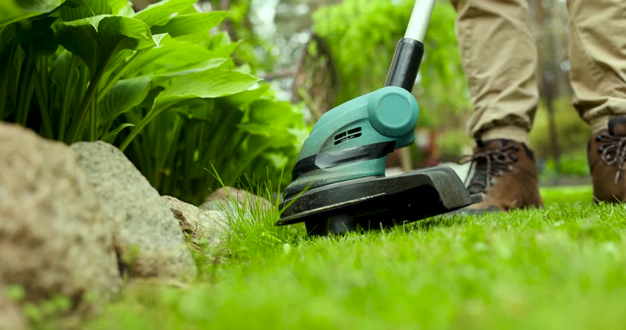 cutting grass with string trimmer. edging lawn