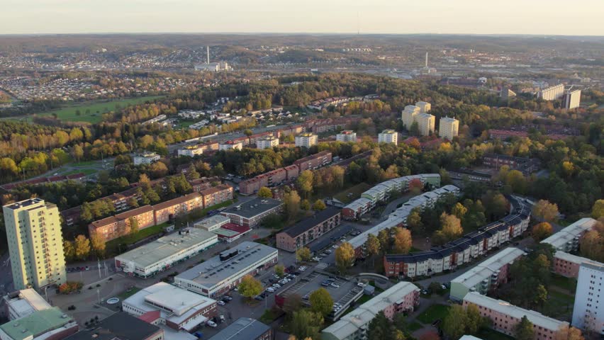 1950s-style Swedish suburb with forest patches, homes, and afternoon sun in Kortedala