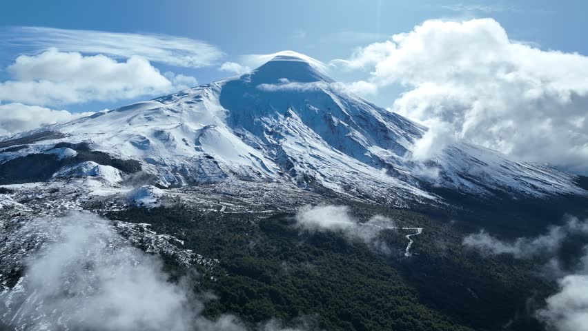 Osorno Volcano In Osorno Los Lagos Chile. Snow-Capped Volcano Releasing Plumes Of Smoke Into Blue Sky. Snowing Day Lake Swiss Alps Snow Mountain. Forest Trees Swiss Alps Nature. Osorno Los Lagos.