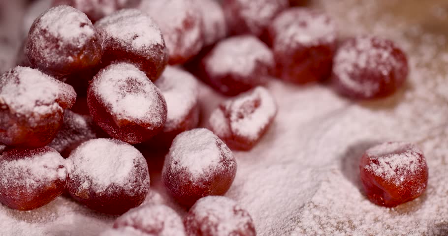 candied fruits of kumquat boiled in sugar syrup in powdered sugar, sweet dehydrated candied fruits of kumquat in white powdered