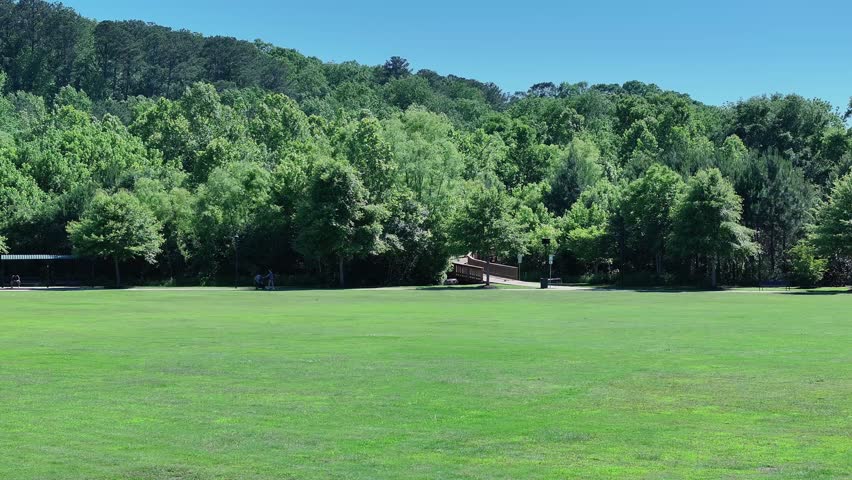 aerial footage of a gorgeous landscape with lush green trees and grass at Etowah River Park in Canton Georgia USA