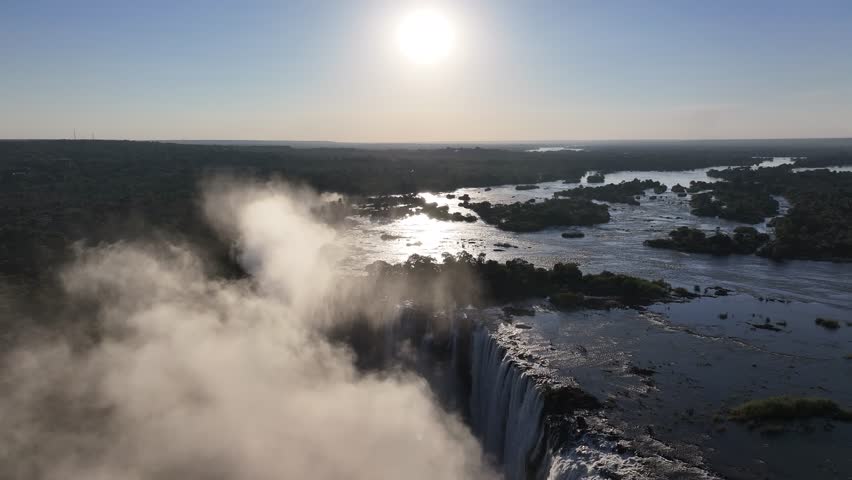 Sunset In Water Falls In Victoria Falls Matabeleland North Zimbabwe. Breathtaking Aerial Footage Of Waterfalls As Natural Wonder. Idyllic Falls Flowing Water Stunning. Canyon Flowing Water Nature.
