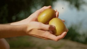 Man holding kiwis while water flows over them. Teenager washing fresh kiwis outdoors under streaming water. Boy rinsing kiwis as droplets splash around - Powered by Shutterstock - Get 15% off with code: PIKWIZARD15
