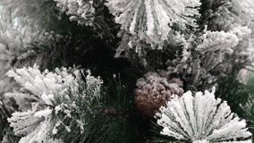 Macro shot of frosted pine needles and a snow covered pine cone on an artificial tree, with soft movement in shallow depth of field - Powered by Shutterstock - Get 15% off with code: PIKWIZARD15