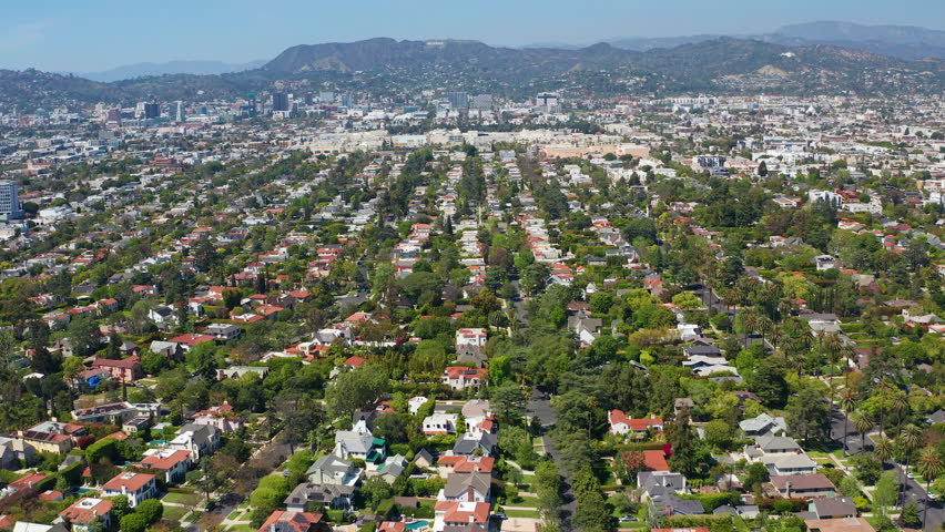 Aerial wide drone shot of Los Angeles residence, homes, Hollywood, green trees - Aerial Drone View