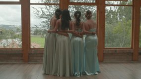 Charming clip of four bridesmaids standing with their backs to each other, turning their heads at the same time to smile at the camera. - Powered by Shutterstock - Get 15% off with code: PIKWIZARD15